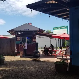 Sushi food cart and some seating.
