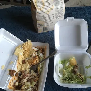two take out containers with food in them