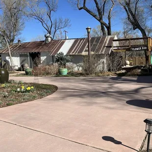 Wine shop and plant  store, with a coffee shop and Maggie's Bar attached under the awning.