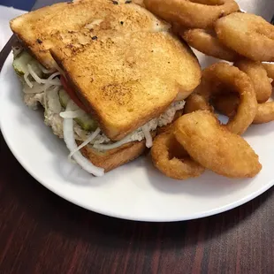 Tuna melt with onion rings.