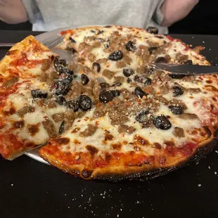 Sausage and olives pizza with a delightful crunchy crust