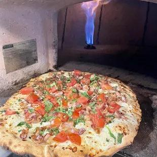 a pizza cooking in an oven
