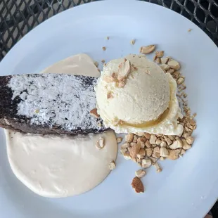 Chocolate cake on bed of cashew cream with vanilla gelato. Mother&apos;s day special. Delicious.