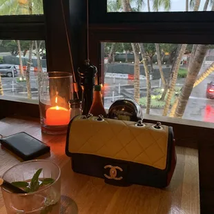 a candle and a purse on a table