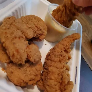 a plate of fried chicken and dipping sauce