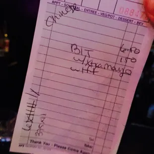 Bartender wrote " Chinese"despite me giving her my name.  She reluctantly handed over the bill.