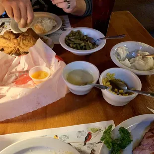 Family style sides with a smoked pork chop and fried chicken. The homemade rolls come with their orange marmalade.