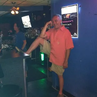 a man leaning on a bar