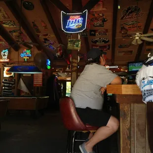 a man and a woman sitting at a bar