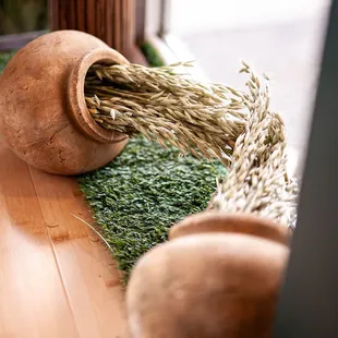 a wooden vase with grass in it
