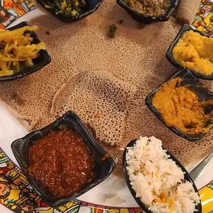 a plate of food with rice, beans, and sauces