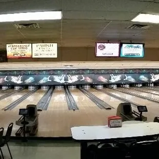 a bowling alley with tables and chairs