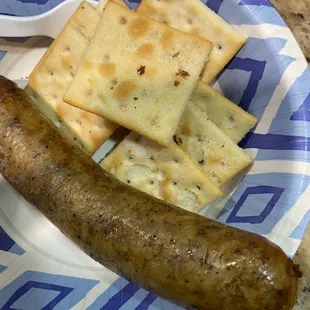 a sausage and crackers on a plate