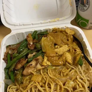 a take out container with noodles and vegetables