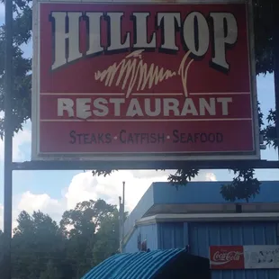 a sign for hilltop restaurant