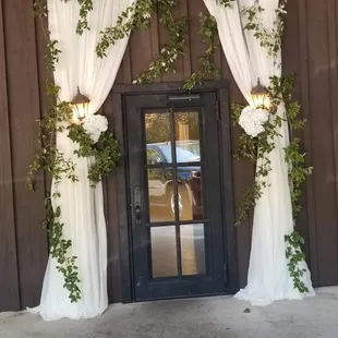 Fabric and ivy wrapping the front door, done by Kevin Griffin.