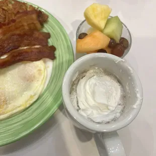  a breakfast of eggs, bacon, and fruit