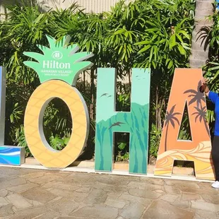 The Mr &amp; I posing at the Aloha sign after checking itn.