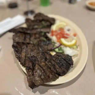 a plate of steak and vegetables