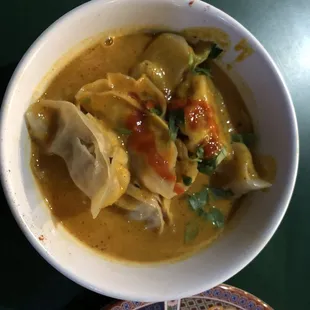Jhol chicken momos: Hot steamed momos dipped in a cold soup.