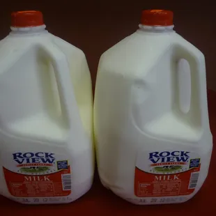 two gallon jugs of milk