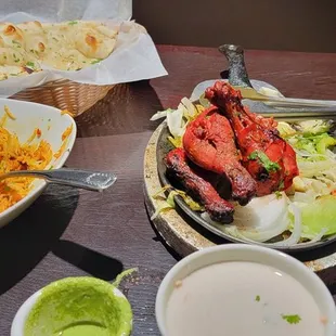 Lamb biryani, chicken tandoori, chicken tikka masala, and garlic naan.