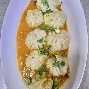 Chili Momo ( handmade Himalayan Dumplings with tomato chili sauce)