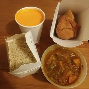Pumpkin curry with brown rice, spinach samosa, and mango lassi