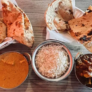 Paneer Tikka Masala with plain naan (left), Vegetable Vindaloo with tandoori roti bread (right)