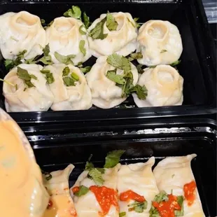 a tray of dumplings being prepared