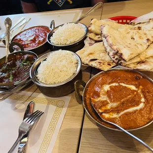 Butter chicken, Paneer chili, Chicken Tikka Masala, Lamb Vindaloo with butter naan bread at Himalayan Grill Scripps Ranch Location.