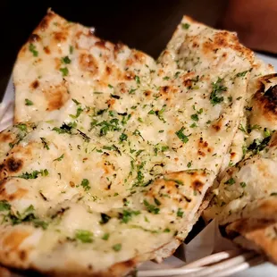 Rather large serving of 1 cilantro garlic naan. The person who took our order graciously told us to order just 1 before ordering another one