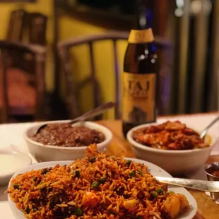 a plate of birya rice with a bottle of beer in the background