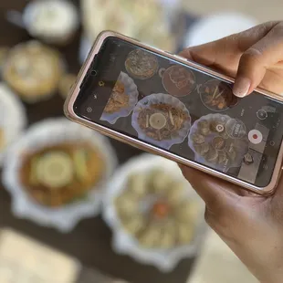 a person taking a picture of food