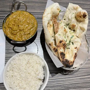 Eggplant curry dish with rice and Garlic Naan