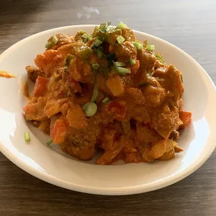 LAMB CHHOILA (boneless lamb marinated in Himalayan sauce, bell pepper, onions, and green onion) cooked in a clay oven with Himalayan spices