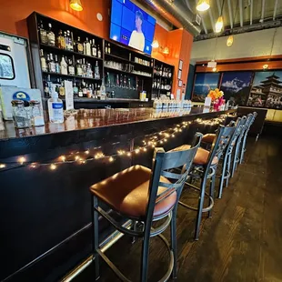 a bar with a row of bar stools