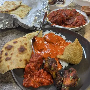 Roti, garlic naan, chicken masala, veggie samosa, wings, chili Momo