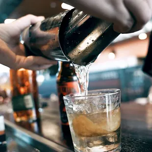 a bartender pouring a drink