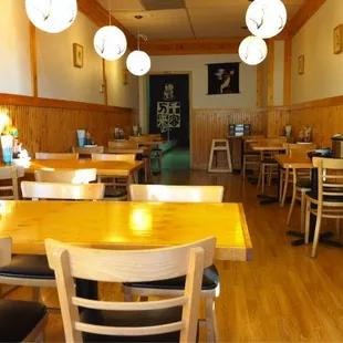 a restaurant with wooden tables and chairs