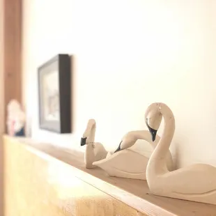 two swans on a shelf