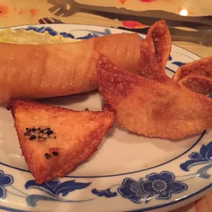 Family Dinner appetizers - shrimp toast, spring roll and crab Rangoon