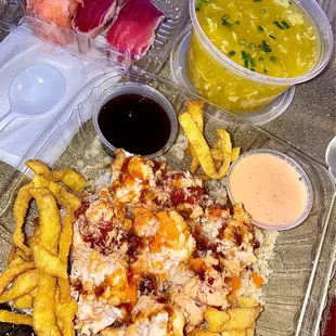 a plate of food with a side of dipping sauces