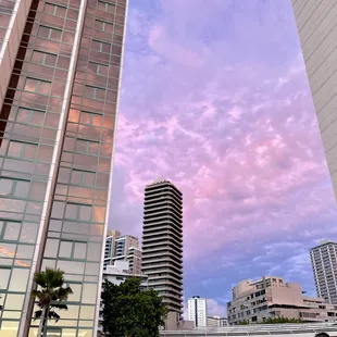 Puffy clouds between the towers, cotton candy like...