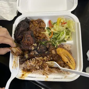 Jerk chicken, oxtail, rice and peas, cabbage, plantain