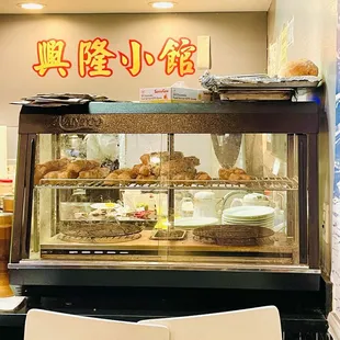 a bakery with a display case full of pastries