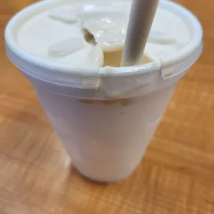 a close up of a plastic cup with a straw sticking out of it