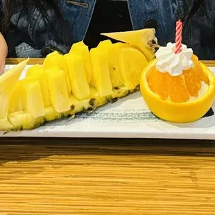 Complimentary birthday fruit platter of a fish and cake