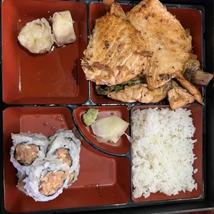 Grilled salmon bento with spicy tuna roll, shumai, white rice and vegetables (underneath salmon)