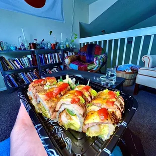 a person holding a tray of food